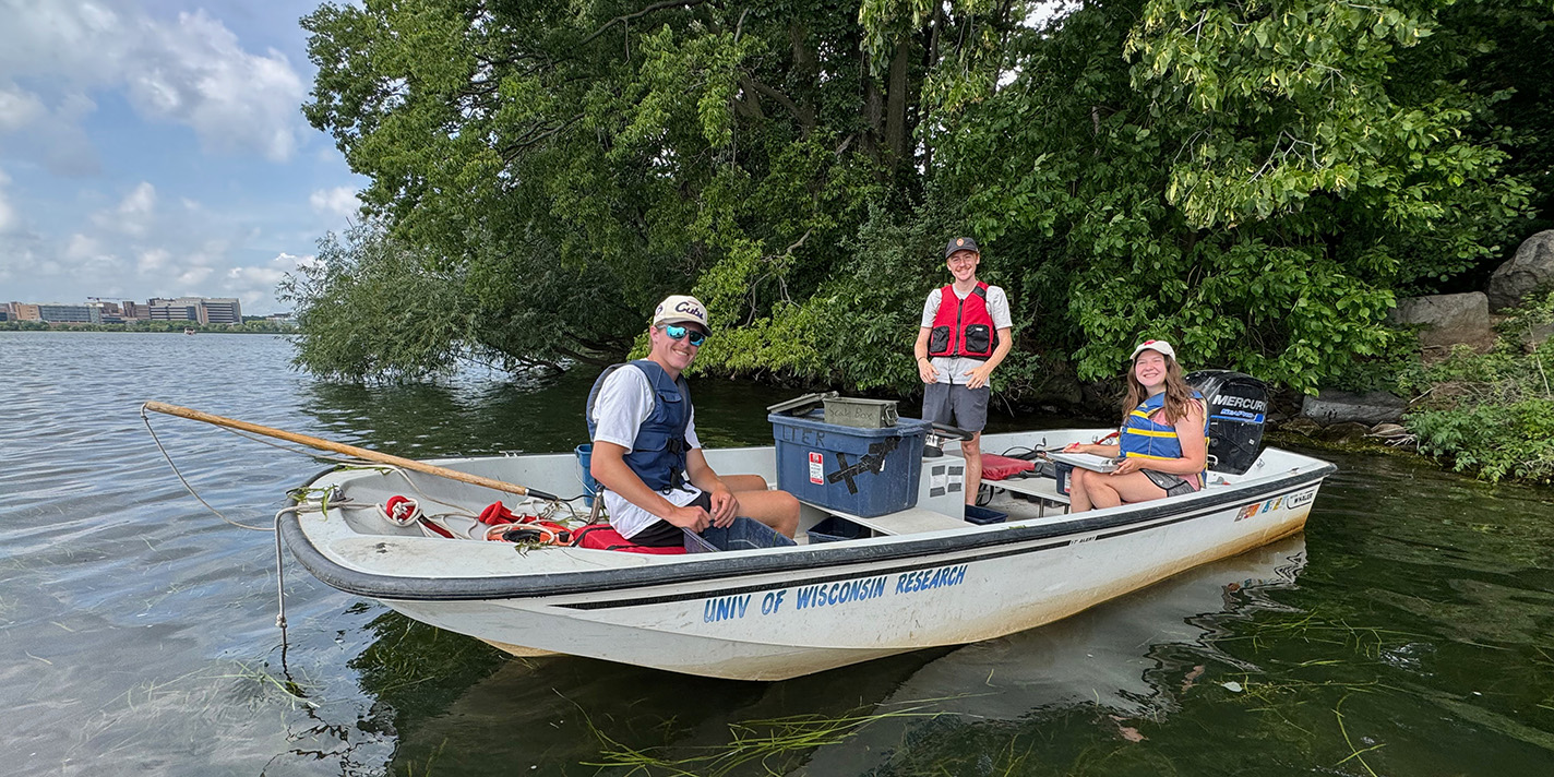 Students analyzing lake samples on a boat