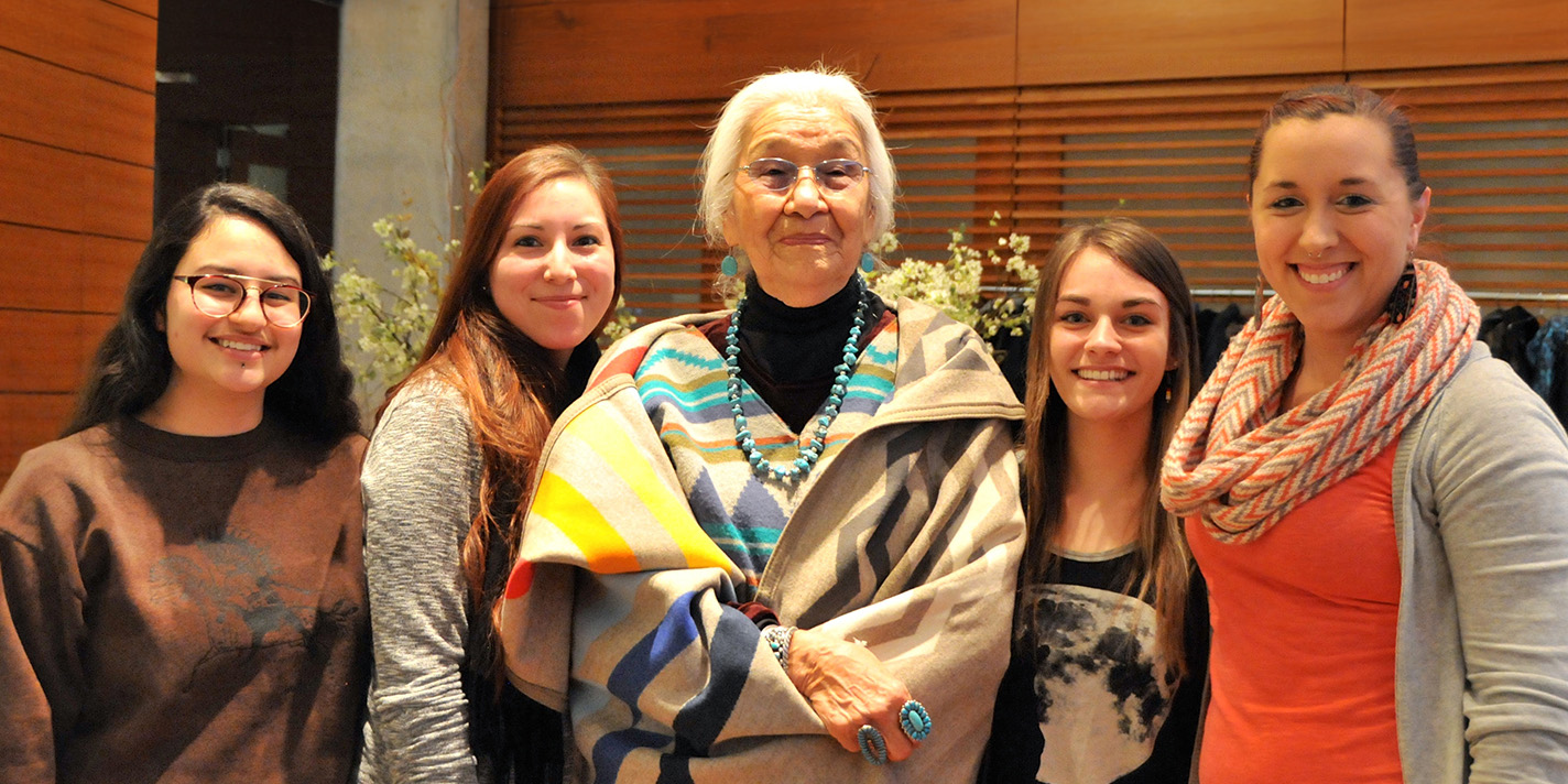 Students pose for a picture with their professor