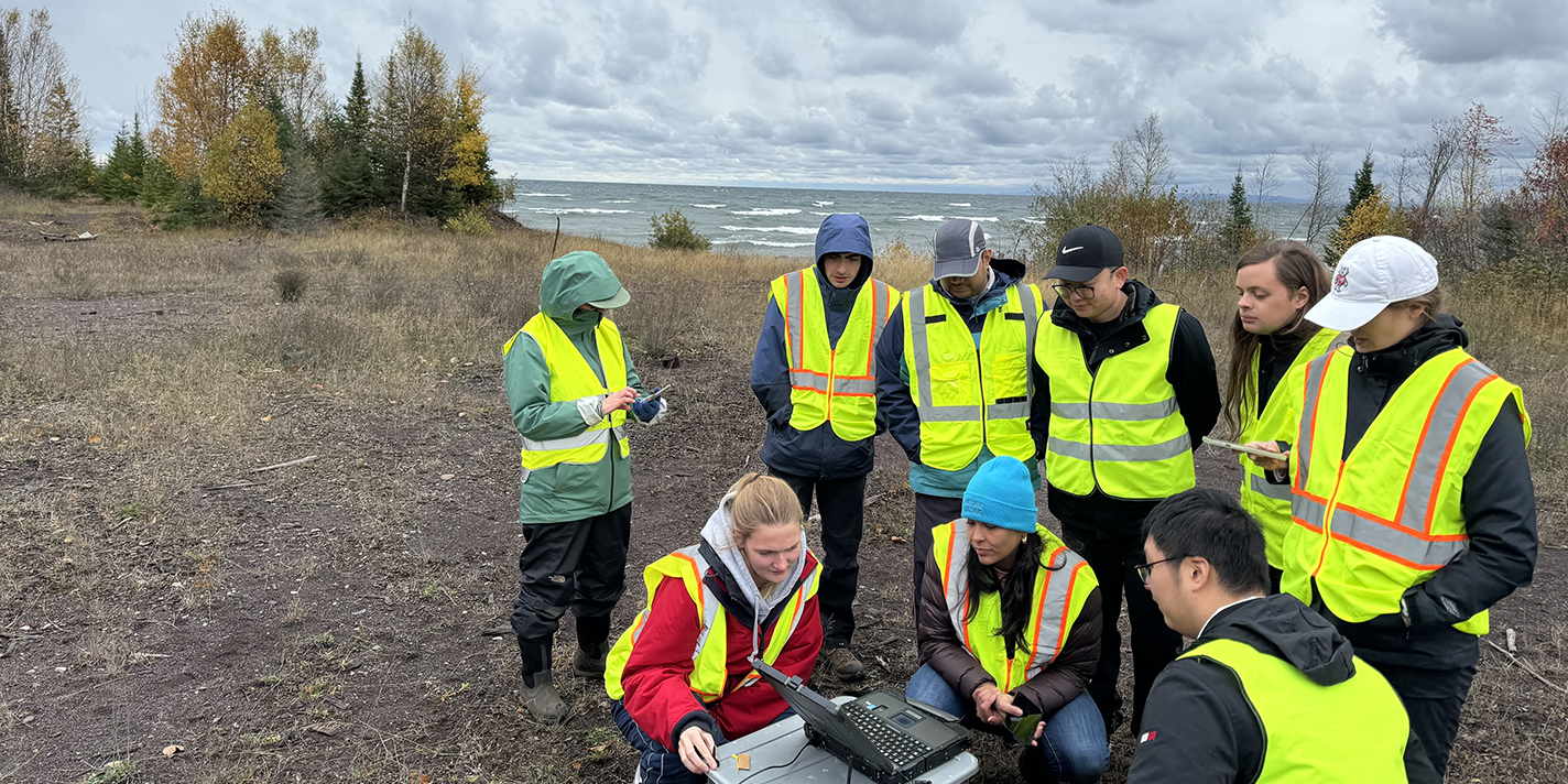 Students monitoring a system near a lake