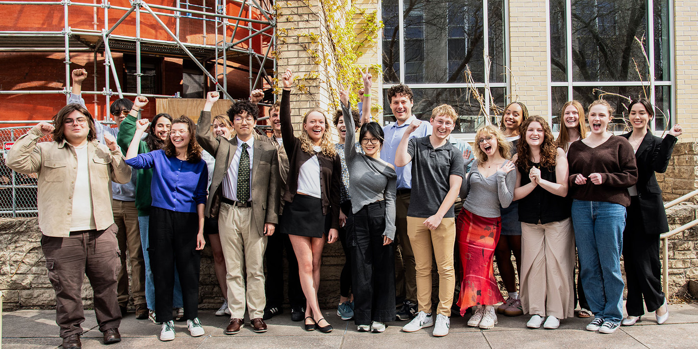 Students cheering, posing for a picture