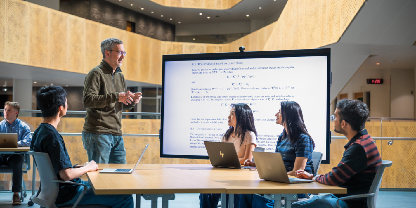 Instructor shown explaining a concept to attentive students
