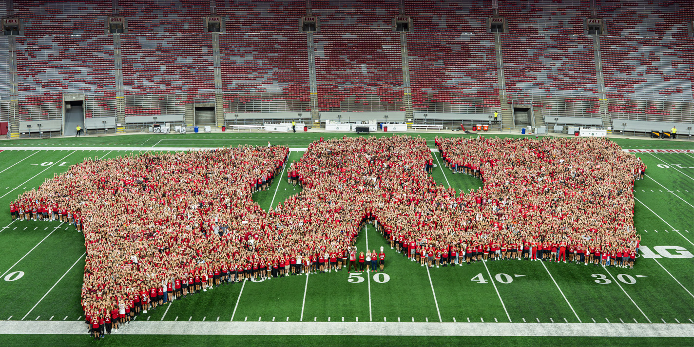 Freshman class pictured at Camp Randall forming a Wisconsin motion W